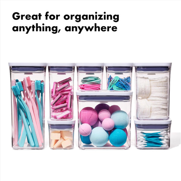 Set of clear storage containers with various items inside on a white background