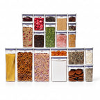 Set of clear storage containers with various snacks on a white background