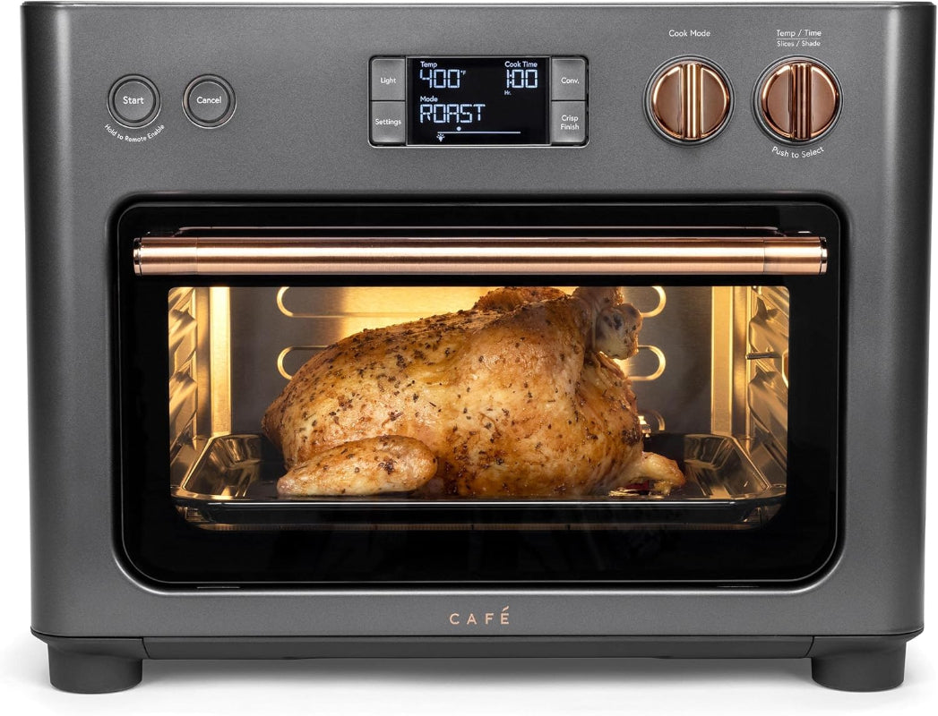 Café toaster oven with a roasted chicken inside on a white background