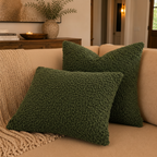 Green textured boho style pillows on a beige couch with a neutral background